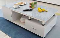 Table basse moderne minimaliste avec cadre en bois blanc et plateau en verre transparent, avec tiroir de rangement pour le salon