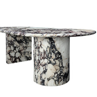 Table à manger asymétrique à double piétement, en marbre massif, avec dalle ovale organique et veinage noir sauvage entrelacé, style minimaliste