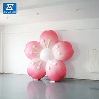 Modèle publicitaire gonflable personnalisé en forme de fleur rose pour la promotion commerciale extérieure printanière