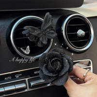 Diffuseur de parfum de luxe noir et or en forme de papillon camélia pour grille d'aération de voiture