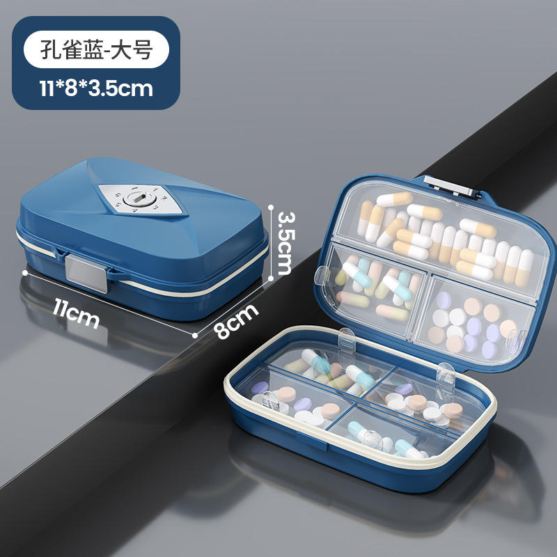 Caja grande de color (azul pavo real) con 7 compartimentos y embalaje en inglés.