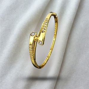 Bracelet ouvert contemporain en finition or avec un design à découpe géométrique et un aspect poli lisse, bijoux élégants pour femmes au quotidien - Product Image 1