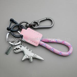 LLavero de aleación de <span class=keywords><strong>dinosaurio</strong></span> pequeño de dibujos animados transfronterizo chica coche cuero cosido a mano cuerda trenzada mochila colgante regalo - Product Image 3