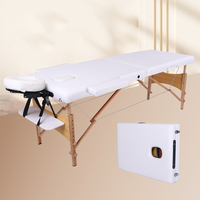 Table de massage portable pliable la plus vendue, structure en bois de hêtre, idéale pour les salons, instituts de beauté, chiropratiques, et tatouages.