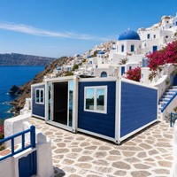 Maison conteneur extensible bleue avec structure blanche, maison modulaire, villa méditerranéenne avec vue sur la mer de Santorin, vente en gros OEM