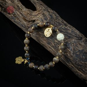 Pulsera de Agarwood Fino con Cuentas de 6mm, Adornada con Dijes de Oro y Acentos de Gemas Tibetanas, Estilo 10, Joyería Elegante - Product Image 1