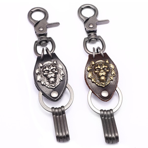 Llavero de cuero con cabeza de león tallada en metal, forma ovalada, color plata antigua y bronce, para colgante de coche. - Product Image 1