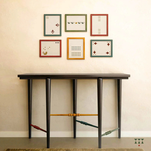Modern Dark Wooden <b>Console</b> <b>Table</b> Featuring Colorful Turned Spindle Crossbars in Red Yellow <b>Blue</b> and Green Against Neutral Wall - Product Image 1