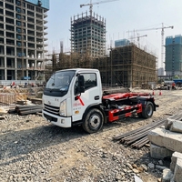 Camion compacteur à bras hydraulique SAIC Yuejin Blue Label Diesel Euro 3 avec benne à ordures interchangeable pour le transfert de déchets