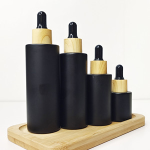 ขวดแก้วใส่เครื่องสำอางสีดำขนาด 30 กรัม แบบกำหนดเองจากโรงงาน สำหรับบรรจุเซรั่มน้ำมันบำรุงเส้นผม ขวดแก้วแบบไหล่เรียบสีด้านพร้อมหัวหยด - Product Image 1