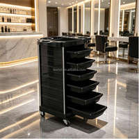 Chariot de coiffure mobile professionnel avec roues verrouillables et plusieurs tiroirs de rangement pour outils et produits de styliste