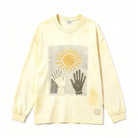T-shirt à manches longues col rond Butter Wash, imprimé graphique rétro soleil, bords effilochés, coupe oversize, style streetwear
