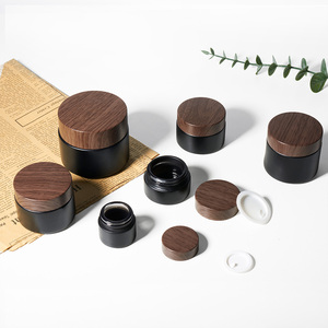 Grosir wadah krim wajah hitam Matte 5/10/15/20/30/50G 1 <span class=keywords><strong>2</strong></span> 4 <span class=keywords><strong>Oz</strong></span> stoples kaca dengan tutup serbuk kayu plastik
