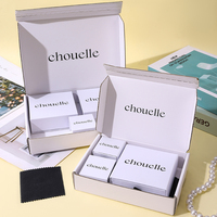 Emballage cadeau sophistiqué pour bijoux en ivoire A1 avec tiroirs de présentation noirs et architecture de boîtes multi-tailles raffinée