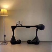 Table d'entrée noire de luxe moderne, console sculpturale créative avec base en forme de goutte pour villa et hôtel