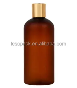 زجاجة لوشن 500 مل للبيع بالجملة عبوة من الكهرمان الشفاف البلوري بغطاء ذهبي ومنفوش علوي للعناية بالبشرة