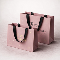Sacs en papier personnalisés de luxe avec votre propre logo pour vêtements, sacs d'emballage pour boutique de vêtements rose mat avec poignées en ruban