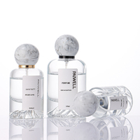 Bouteille de parfum ronde de fond de montagne de volcan de 50ml bouteille en verre de pulvérisateur à sertir vide clair avec couvercle à bille en résine de luxe