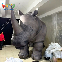 Accessoires de cinéma : Rhinocéros gonflable géant et réaliste pour événements sur le thème de la migration animale, décor de scène gonflable