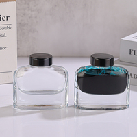 Bouteille d'encre vide en verre transparente carrée et plate de 50ml au design de haute qualité personnalisée avec couvercle en plastique noir, vente en gros
