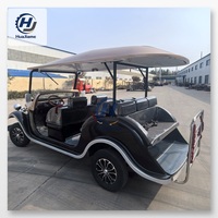Voiturette de golf électrique noire et champagne au style vintage pour le transport dans les complexes hôteliers et l'hôtellerie