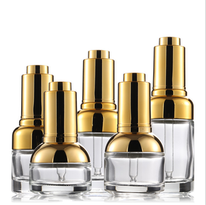 Flacon compte-gouttes en verre épais pressé avec bouchon à épaule doré et argenté de 20/30/50 ml avec impression sérigraphique pour huile essentielle - Product Image 1