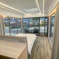 Maison capsule moderne de luxe en acier préfabriquée de 40 pieds, 1/2 chambre, mini-maison Apple, capsule spatiale solaire, salon, salle de bain pour usage hôtelier