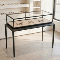 Vitrine d'exposition en verre trempé avec cadre en métal noir pour lunettes, meuble de magasin d'optique, fabricant