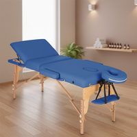Table de massage pliable portable de luxe avec pieds en bois et revêtement en cuir synthétique – Lit de massage confortable et multifonctionnel pour traitements variés