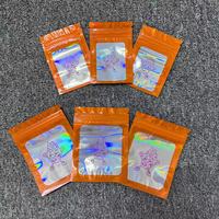Bolsa de plástico para embalaje de Mylar con cremallera láser holográfica naranja transparente a prueba de olores resellable de grado alimenticio con logotipo personalizado