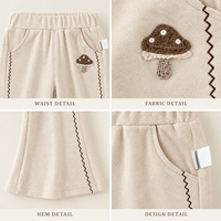 Pantalon évasé ivoire pour filles avec applique champignon, bordure de jambe en zigzag et poches latérales pour collections de vêtements pour enfants en gros et sur mesure