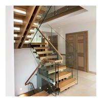 Escalier moderne durable et écologique à monopoteau, avec garde-corps en acier inoxydable et marches en bois, pour hall intérieur et sous-sol
