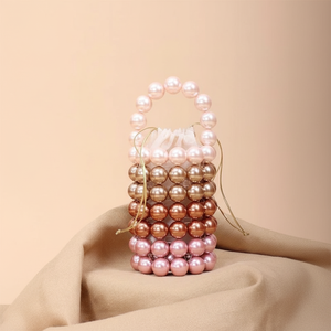 Fashionable vertical <b>bucket</b> style <b>bag</b> featuring multi-toned pink and bronze gradient <b>pearl</b> rings, available at wholesale prices. - Product Image 1
