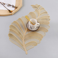 Vente en gros de napperons en PVC en forme de feuille noire dorée, tapis de table tissés design pour la cuisine, la maison, le mariage, la décoration et la voiture.