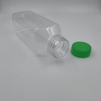 Bouteille de boisson de jus en plastique PET jetable en gros bouteille d'eau en plastique transparente vide mince avec couvercle bouteille de boisson