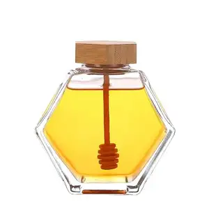 Venta al por mayor 380Ml 13oz Botella de vidrio de perfume en forma hexagonal Botellas de vidrio de miel con varilla agitadora y tapa de madera de bambú