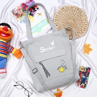Nouveau design en gros style simple grands sacs à bandoulière livre d'étudiant sac d'école fille femmes sourire toile sac fourre-tout
