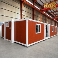 Maison conteneur extensible moderne Huaying de 40 pieds avec cadre noir et jaune désert, étanche et coupe-vent, garantie 5 ans