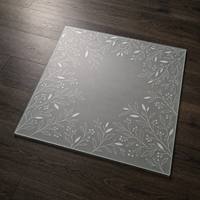 Plateau de table en verre trempé de sécurité avec un motif botanique sur le bord et un centre ouvert et épuré.