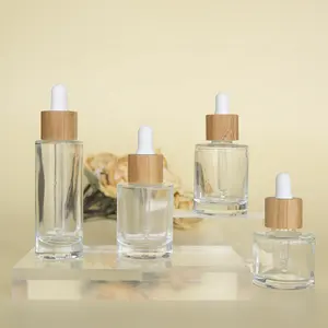 Free Sample 2022 Wholesale High Quality Essential Oil Cylindrical Bamboo Cap Flat Shoulder Empty Glass Clear Dropper Bottles