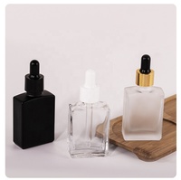 Bouteilles rectangulaires d'huile essentielle de 1oz Barbes 15ml 30ml 50ml 100ml Bouteille carrée en verre noir mat givré Cosmétiques