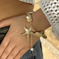 Nouveau Collier de style international pour femme, multicouche, massif, en alliage doré, avec perles imitation perle, perles en forme d'étoile de mer et coquillages, style Europe-Amérique, de niche