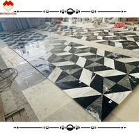 Incrustation de marbre noir et gris assortie blanche pure personnalisée carreaux de marbre jet d'eau modernes motif de sol design