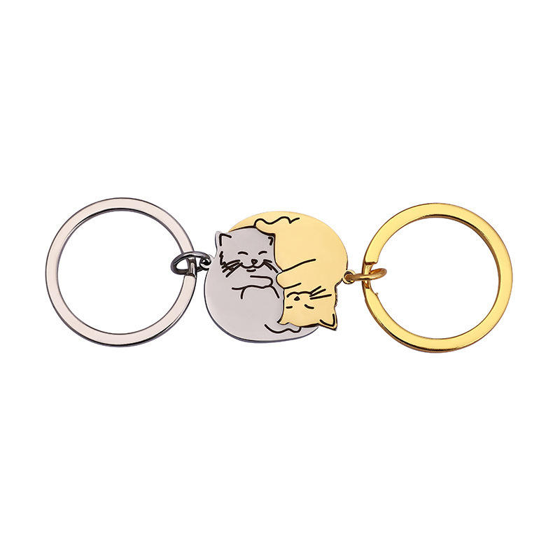 A pair of steel color + gold keychains