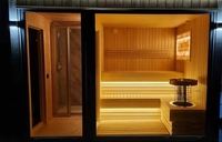 Sauna en bois massif gris foncé écologique avec porte coulissante, sièges à plusieurs niveaux, design moderne pour usage commercial