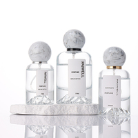 Bouteille de parfum ronde de fond de montagne de volcan de 50ml bouteille en verre de pulvérisateur à sertir vide clair avec couvercle à bille en résine de luxe