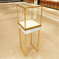 Vitrine d'exposition de bijoux sur mesure avec cadre en métal doré et tiroir en bois, plateau en verre pour l'aménagement de magasins de vente au détail de montres et de diamants