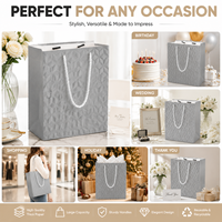 Sac en papier gaufré de luxe prêt à commander avec poignée en corde, service de logo personnalisé, fond durable pour emballage cadeau de magasin de vêtements