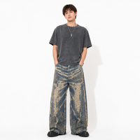 Pantalon ample pour homme, délavé, bleu moyen, avec broderie géométrique dense à motifs circulaires et runiques, coupe à franges horizontales, jambe large