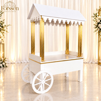Chariot à desserts blanc avec colonnes dorées, toit en pente et roues à rayons pour mariage, fête, hôtel, événement, service de personnalisation